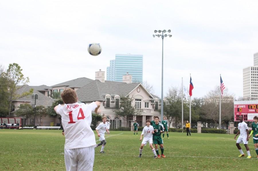 Freshman Owen Torczon tosses the ball back into play during the JV team’s match against Awty International, Jan. 30. Despite a strong upperclassman presence on varsity, the team depends on promising underclassmen to fill their shoes each passing year.