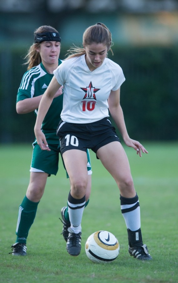 Sophomore Gracie Firestone dodges an opponent as she takes the ball down the field during the team’s match against Awty International, Nov. 19. The team won 2-0.
