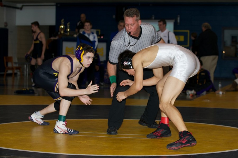 Sophomore Raymond Yuan faces off against a Kinkaid wrestler during SPC last year. Despite the loss of key seniors, the team hopes to continue their success.