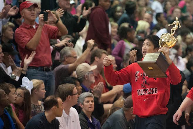 Senior captain Sean Yuan cheers on classmates at the SPC basketball championship after the wrestling team’s victory.