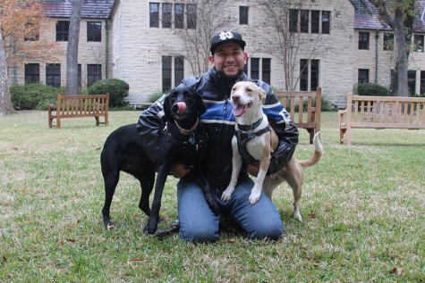 Photography teacher Chuy Benitez with Ruby, the black lab, and Sally, the mutt