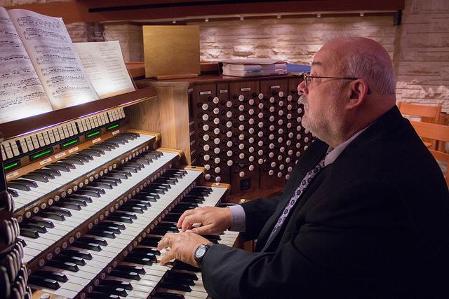 Accompanist Donald Doucet plays the organ in the back of St. John the Divine during Chapel. Doucet has been accompanying the schools choirs and bands since 2002.