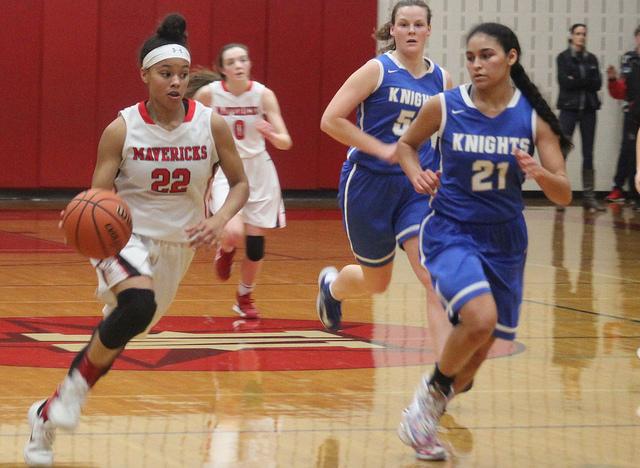 Senior Gabby Otey rushes down the court with possession of the ball.