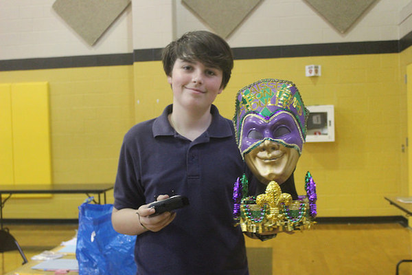 Freshman Clyde Johnson presents the remote-controlled sculpture he made of a Mardi Gras Mask. This years Symposium theme was La Louisiane.