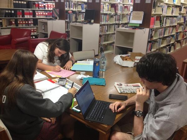 From left: juniors Julia Giordiano, August Schwanauer and Austin Schultz study intensely for their physics and math finals.