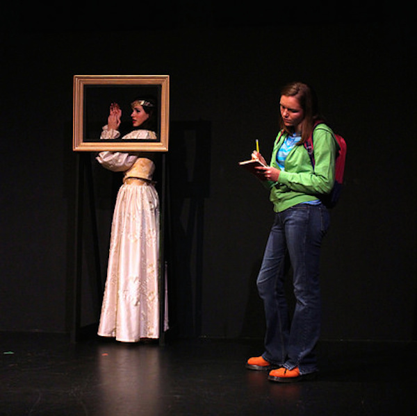 Junior Devon Granberry, playing frustrated high school student Liz, studies the portrait of medieval Italian Elisabetta, played by junior Ella Rose Arnold. 