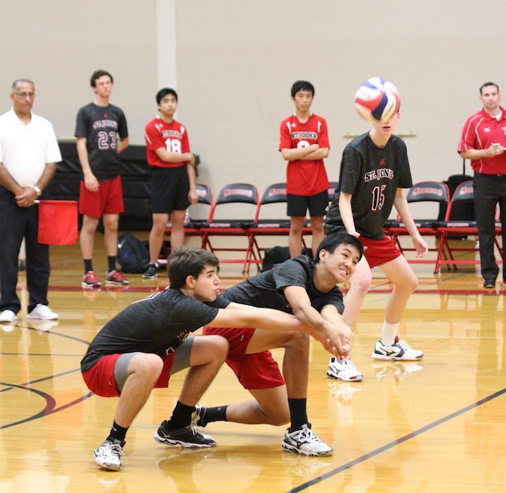 Senior Erik Andrade and junior Gregory Dayao dive for a pass. (Anthony Dayao)