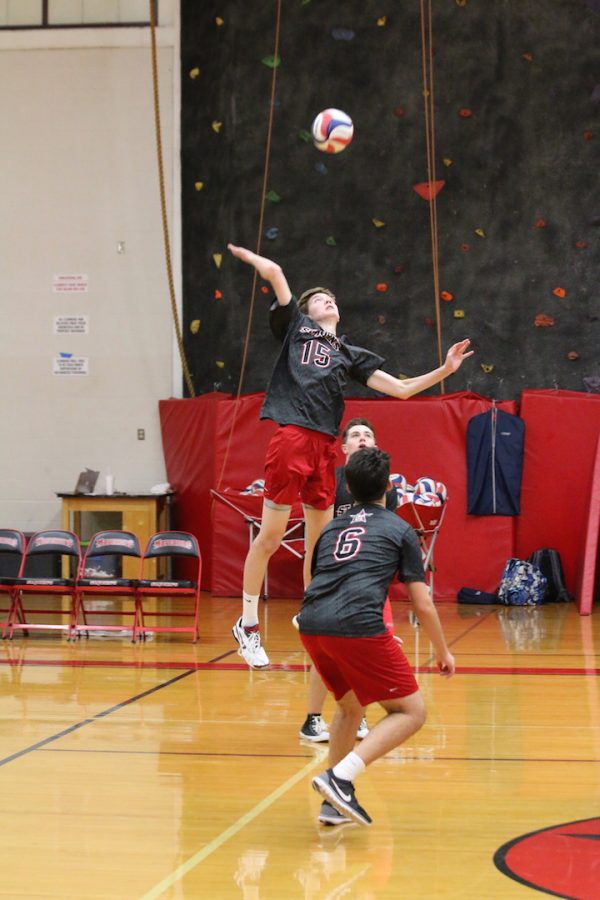 Captain Michael Urdahl jumps for a spike at a game against Kinkaid Sept. 15.