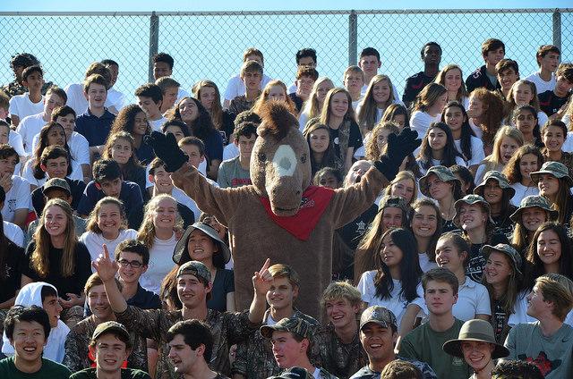 The Maverick horse cheers in the stands among the Upper School students.