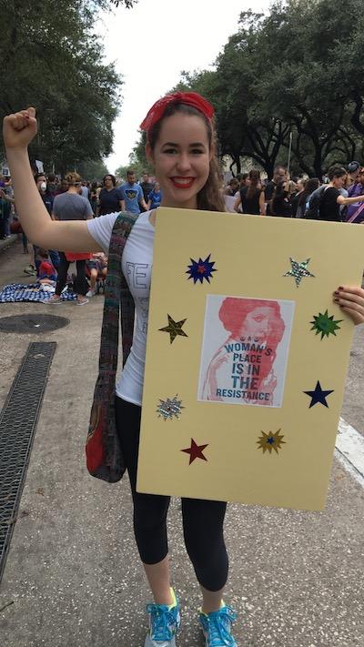 Sophie Caldwell emulates Rosie the Riveter while displaying her poster featuring the late Carrie Fisher.