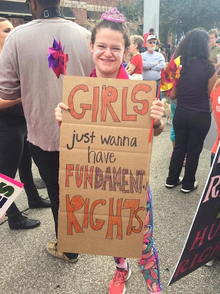 Ellie Faraguna shows off her sign for Houstons march.