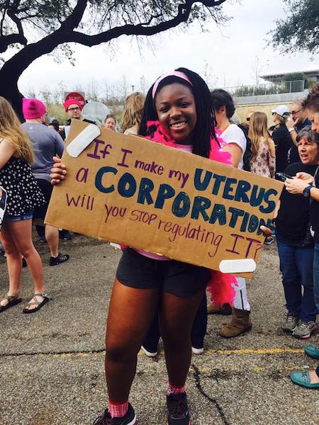 JaDa Johnson displays her sign amidst a crowd of marchers in Houston.
