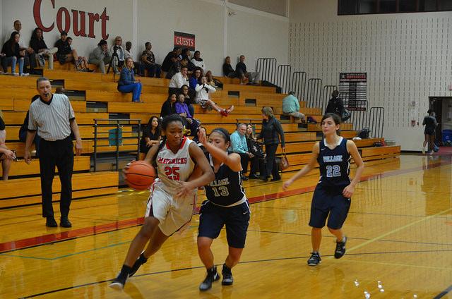 Sophomore Lena McZeal dribbles past a Village defender.