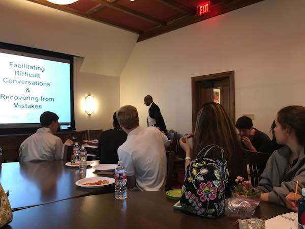 Dr. Frank Dobson, far back and center, converses with students during a Q&A session.