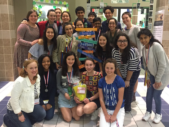 The group celebrates their second place trophy after the awards ceremony. 