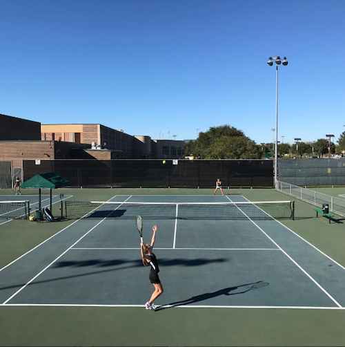 Girls tennis member Hannah Johnston plays singles against Stratford. Although boys tennis is making cuts, girls tennis has a total of 32 girls players on Varsity and JV, including one senior on JV. 