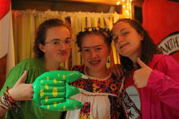 Sophomore Sarah Jane Lasley (left) dressed as a dinosaur with two other friends from Rockbrook. Dressing up is an important part of Banquet. 