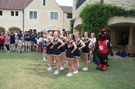 The Varsity cheer squad leads students in a cheer.