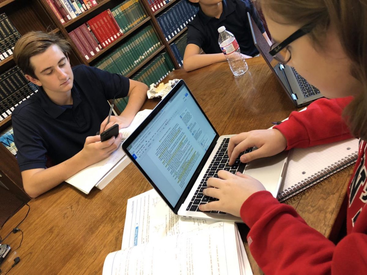 Students enjoy the improved internet as they work in the library. 