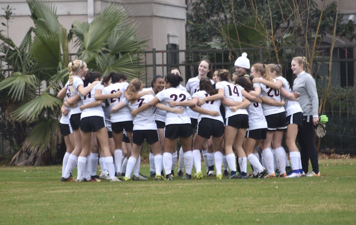 The team gathers for a pregame huddle.