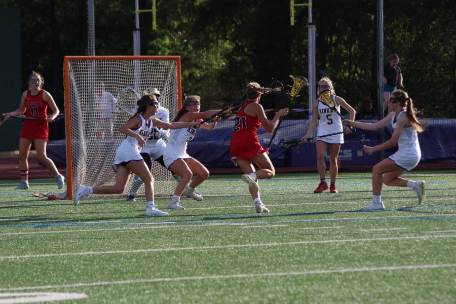 Freshman Caroline Pressler passes several Kinkaid defenders.