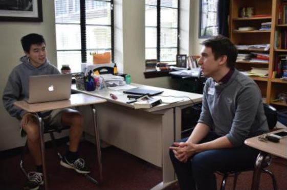 Debate coach Andrew Stubbs advises senior team captain Andrew Wan on his case. Since the implementation of the new schedule, the debate program has grown, leading students to garner a number of awards at local tournaments.