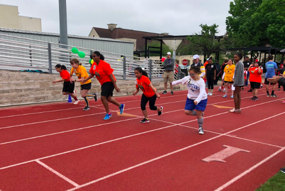 Athletes begin their race as spectators cheer them on.