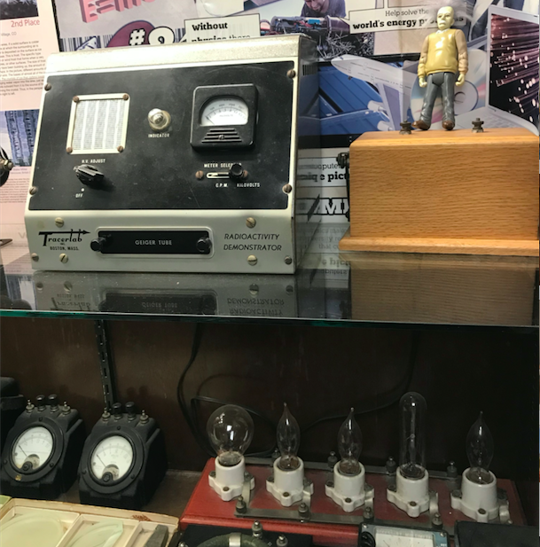 The display case in freshman hallway features several generations worth of physics equipment.