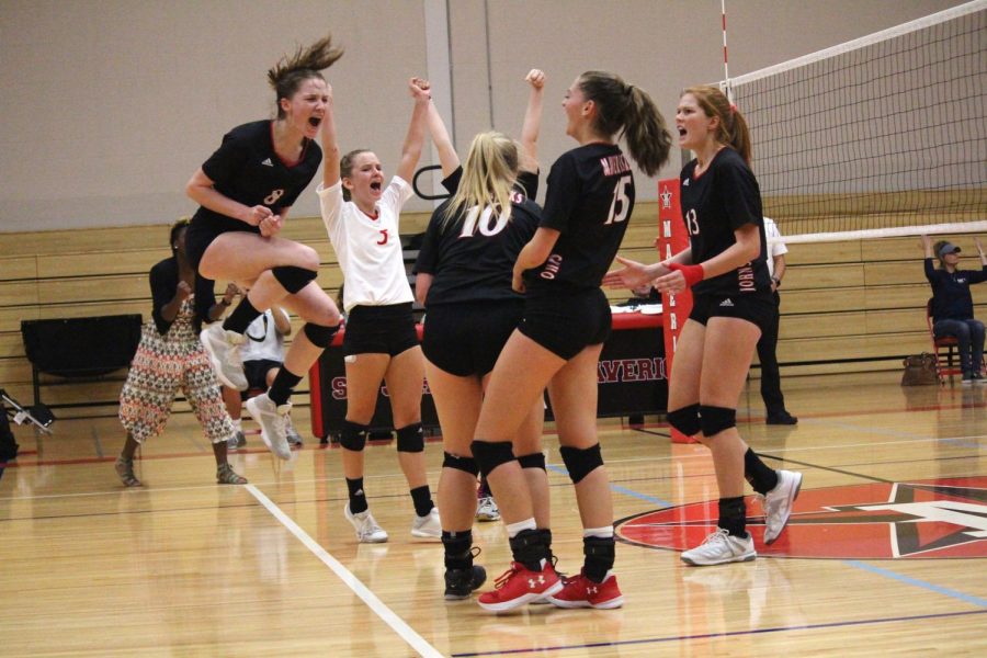 The team celebrates after winning a point.