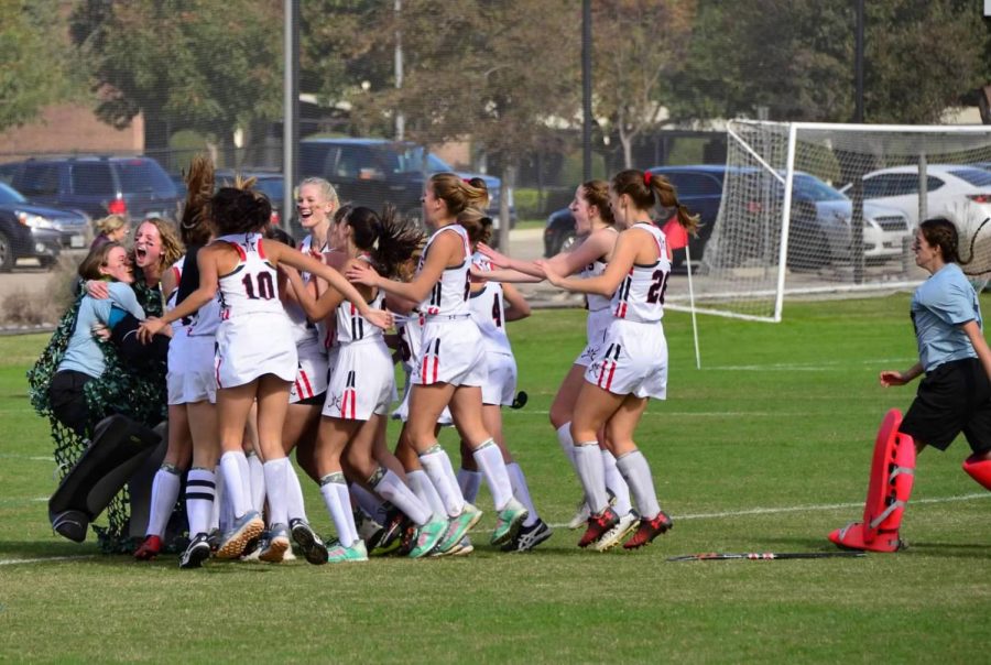 The team swarms the field after their victory over Kinkaid.