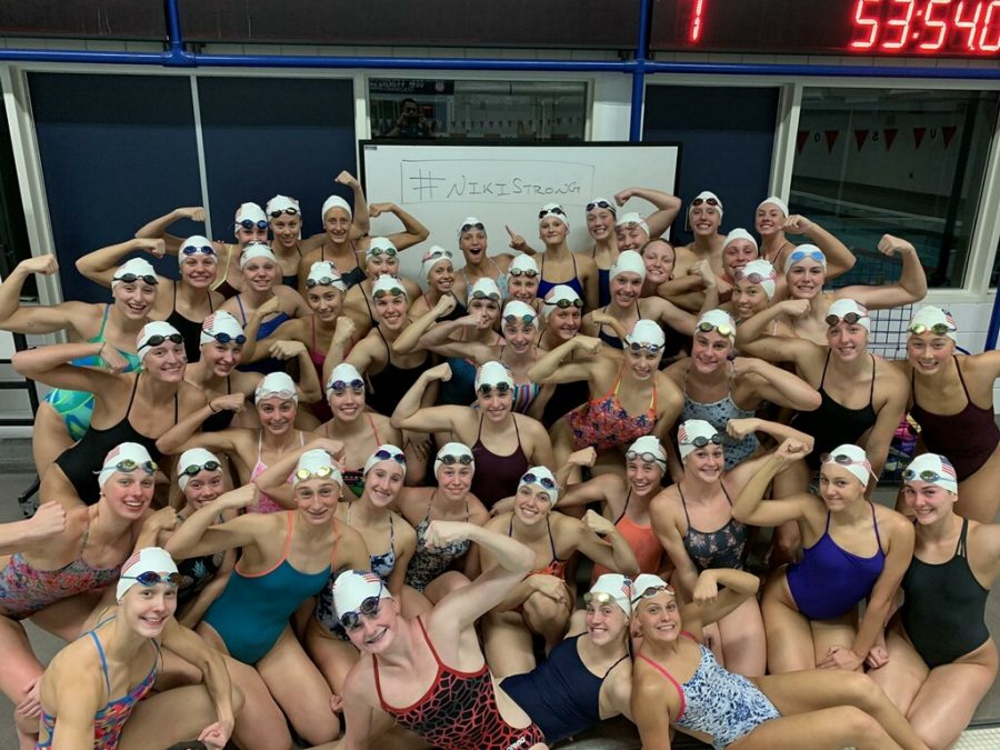 Ella Flowers poses with other swimmers at the Olympic Training Center.