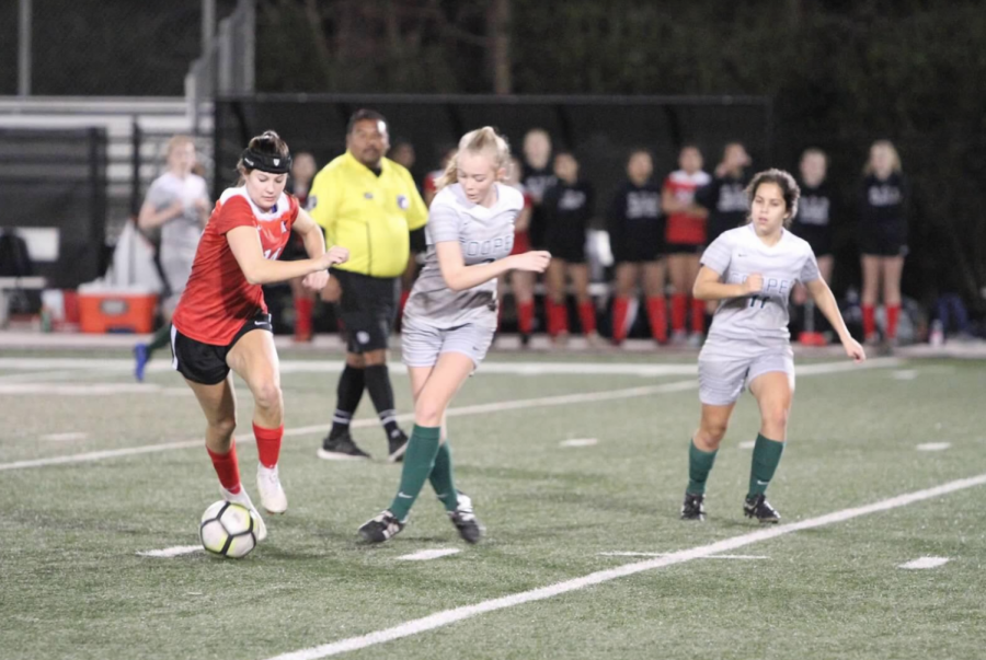 Captain Camila Sabisky dodges a John Cooper defender. 