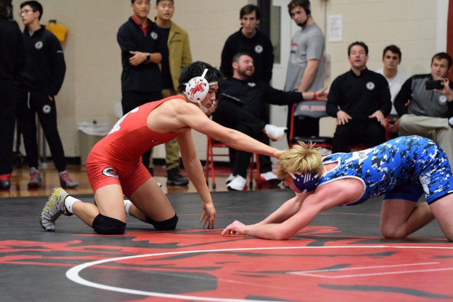 Sophomore Thomas Chang squares off with his opponent. Chang was one of the 14 wrestlers who represented the Mavericks at SPC.