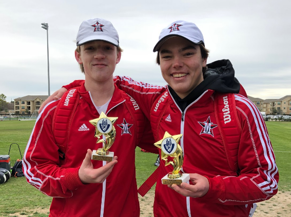 Captain Jackson Edwards and sophomore George Caldwell show off their trophies. 