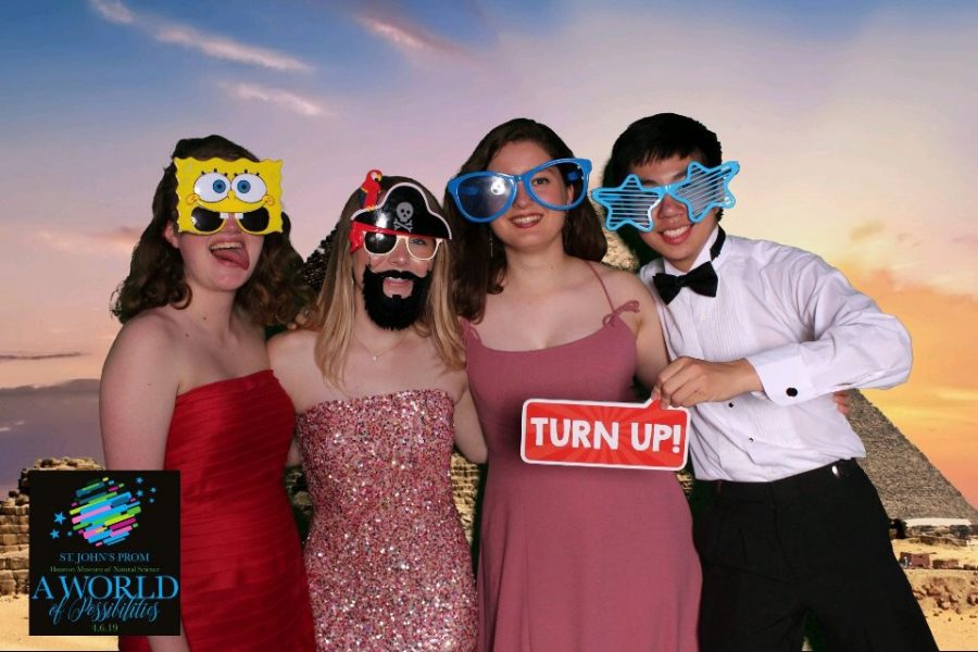 Assignments Editor SJ Lasley, Online Section Editor Sinclair Mott and Online Editors-in-Chief Sophia Kontos and Ryan Chang pose with props from the photo booth. 