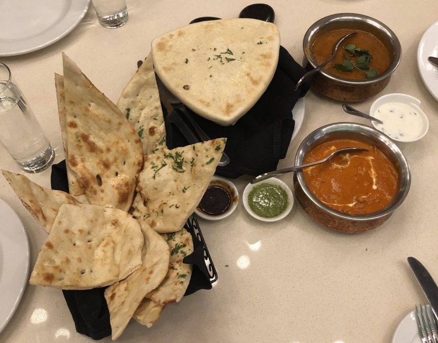 Bowls of butter chicken and garlic naan were served as the main dish.