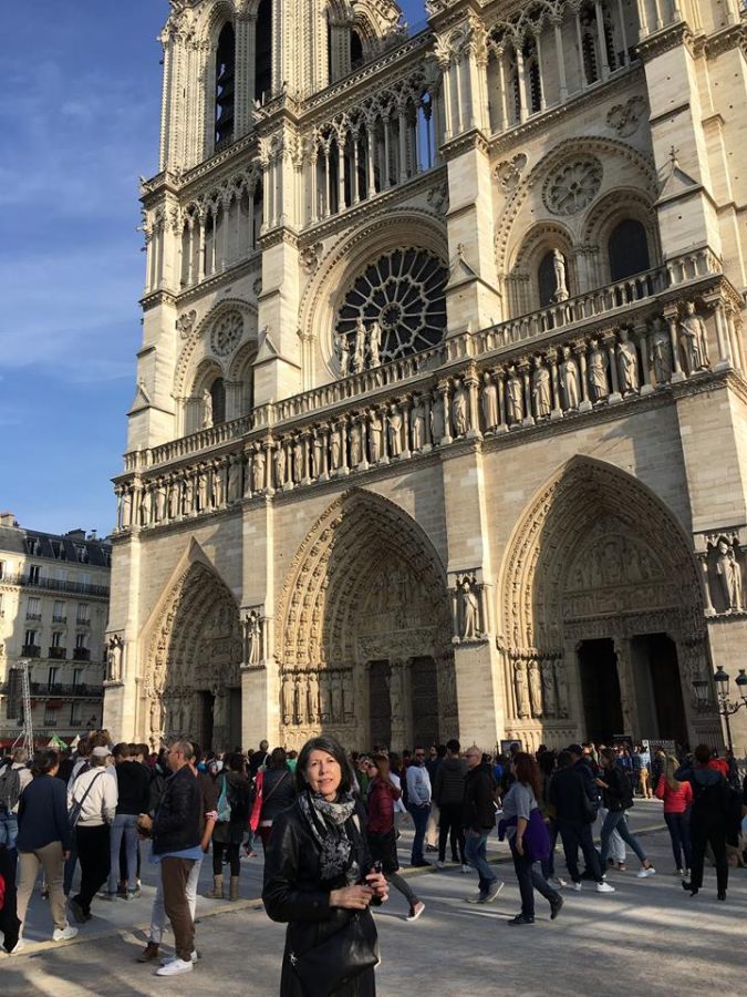 Former English teacher Linda Carswell, who currently lives in Paris, poses in front of the cathedral.