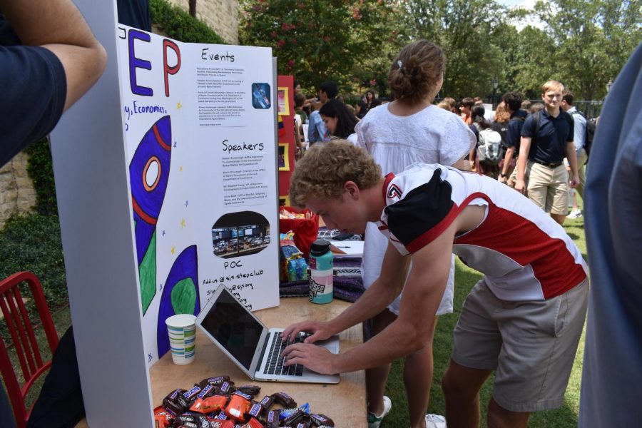 New clubs draw attention from the crowds with their colorful signs and offerings of sweet treats.