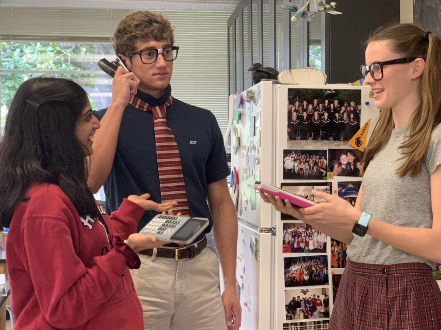 Kinkaid seniors mock the nerdy side of SJS students with stereotypical nerd glasses and TI-84 calculators at the ready.