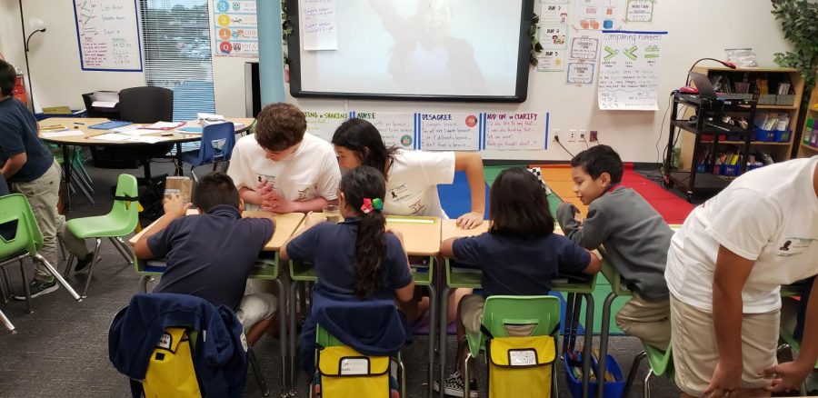 Freshmen read Seeds to Pumpkins to students at KIPP SHARP.