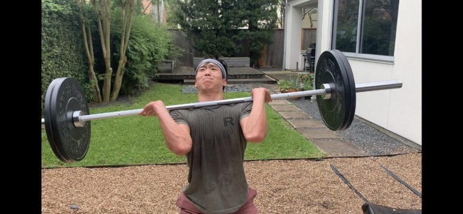 Thomas Chang lifts weights in his backyard.
