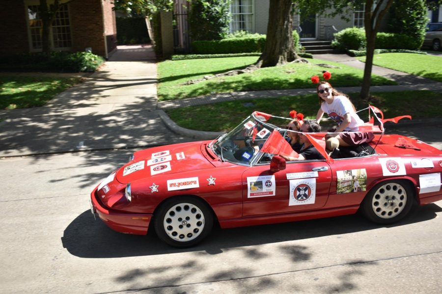 Jacqueline Heal rides through the parade in a car decorated in Maverick and University of Edinburgh stickers.