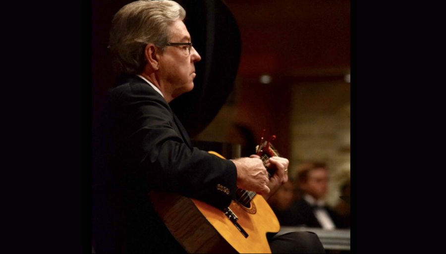Darrell Parrish plays a guitar accompaniment for choir at Candlelight in December 2018.