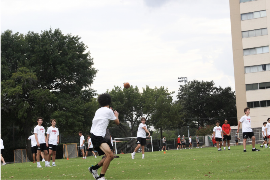 The football team conducts a drill for their quarterbacks and receivers.