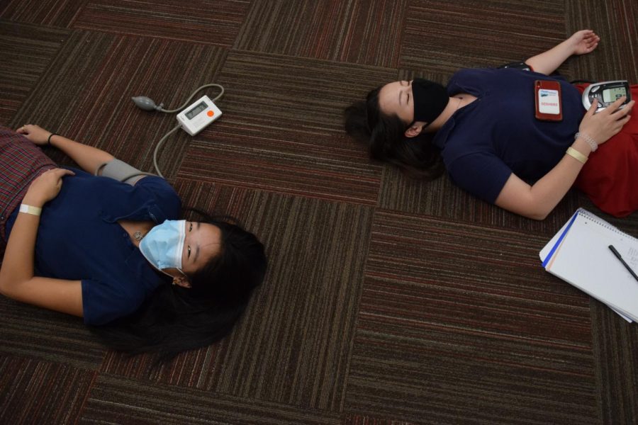 Seniors Hannah Chang and Nicole Doyle take their blood pressures as part of an Anatomy and Physiology lab.