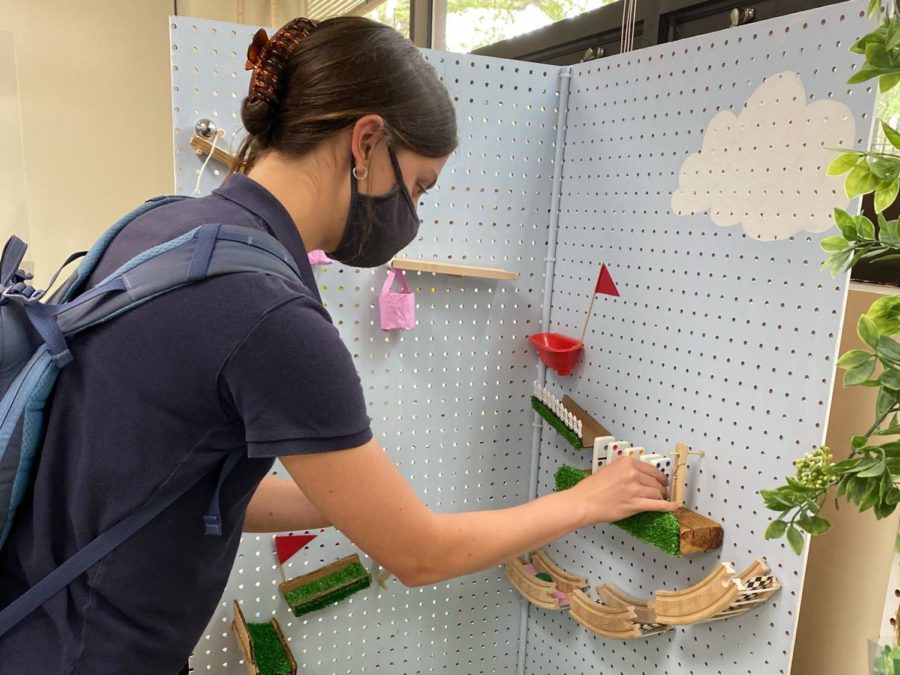 Hannah Garrou lines up the dominos on her golf-themed machine.