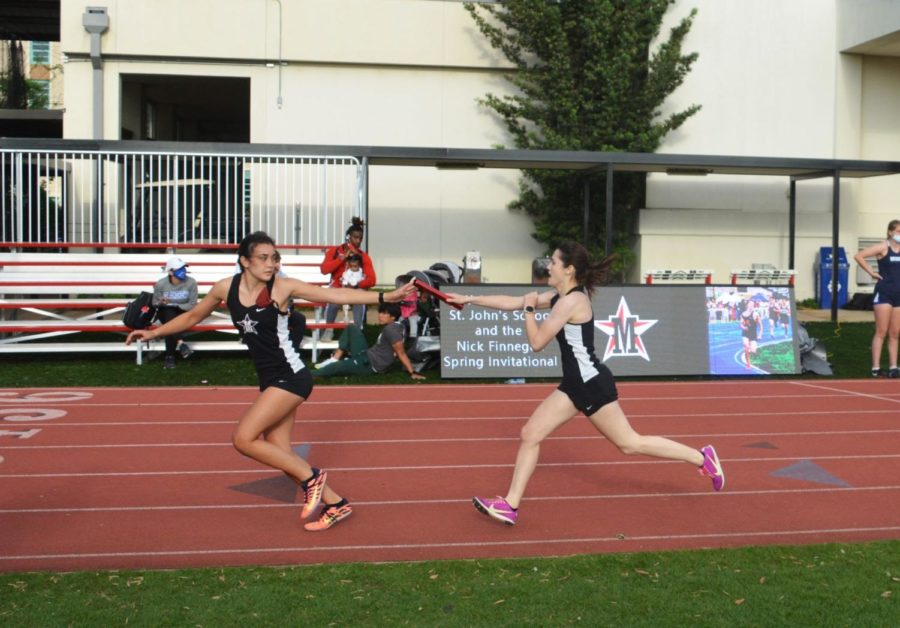 Junior Cici Calhoun passes the baton to senior Reese Ramirez in the 4x400m relay. The girls’ track and field team placed sixth in the SPC Championship on May 8. 