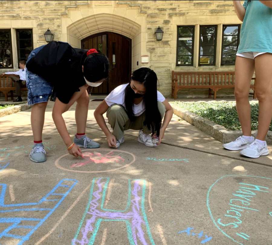 Freshmen Serina Yan and Alexys Shae Tantuco collaborate to sketch their advisorys mascot and logo on the Plaza. Every freshman signs their name adjacent to the chalk creations. 