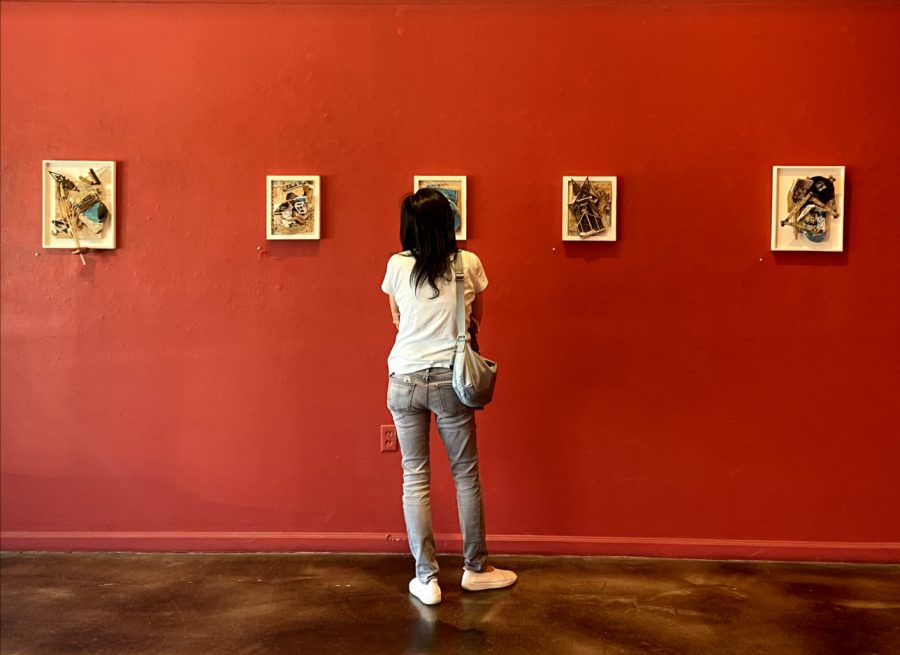 A woman studies the details of one of Havel’s collages, Rafter. The pieces from left to right: Excuse My Scribbling, Square Deal, Rafter, Gothic Rupture and  Taking Measure.