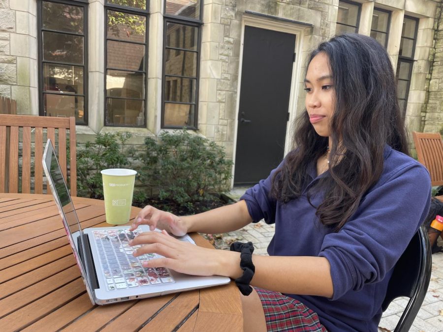 Senior Kate Vo works on her college essays on the Quad. 